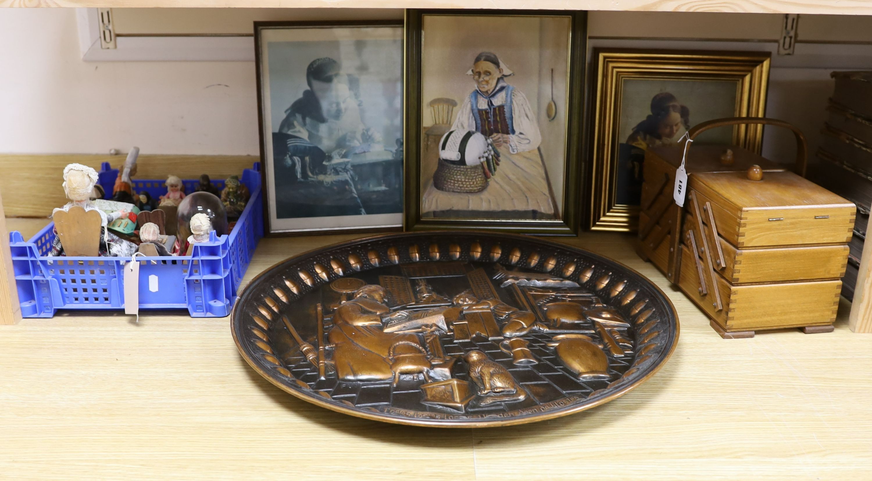 A collection of lace maker's bobbins, cast silver lace-maker under glass dome, related copper wall plate, figures and prints